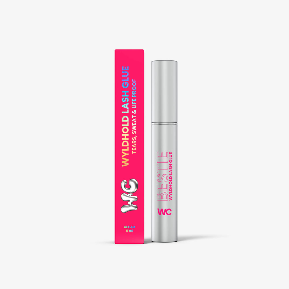 WyldHold Lash Glue clear brush-on adhesive tube next to its pink Wyld Chics box